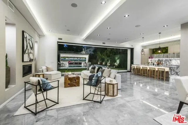 a kitchen with stainless steel appliances granite countertop sink stove and white cabinets next to a window