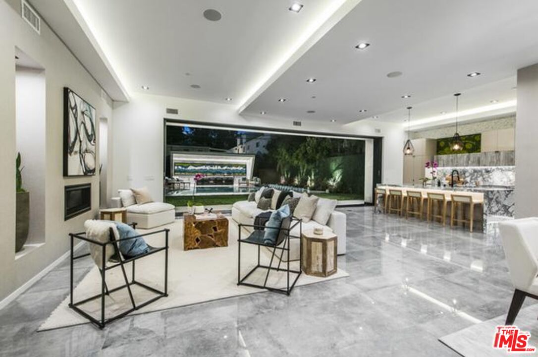 11241 Blix Street Toluca Lake, CA 91602 - Photo 5 of 19 a living room with fireplace furniture and a flat screen tv