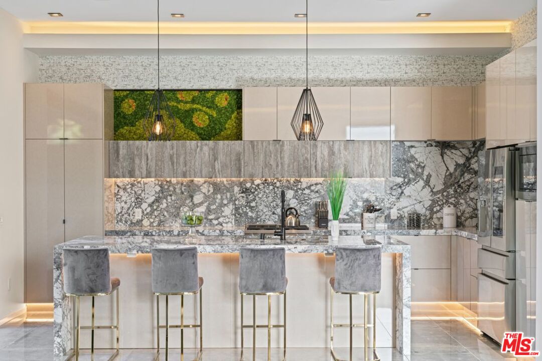 11241 Blix Street Toluca Lake, CA 91602 - Photo 7 of 19 a kitchen with a table and chairs