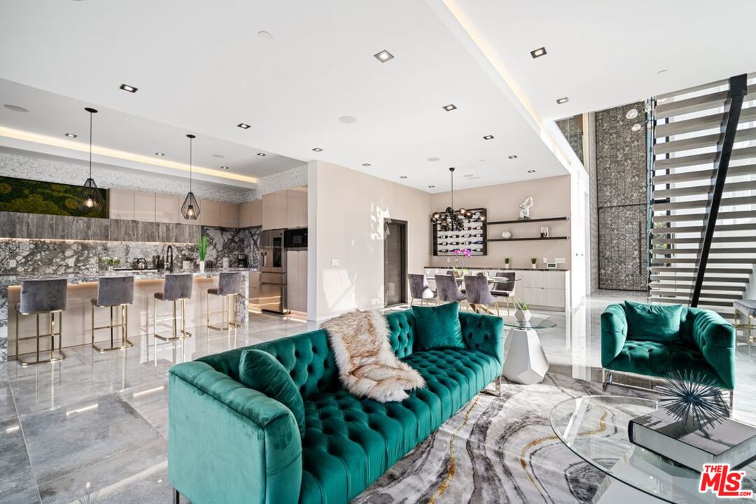 11241 Blix Street Toluca Lake, CA 91602 - Photo 8 of 19 a living room with furniture and a flat screen tv