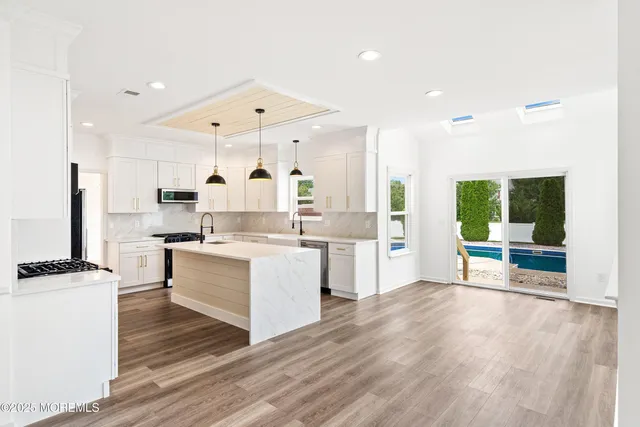 a view of empty room with wooden floor and fireplace