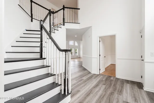 a view of entryway and hall with wooden floor