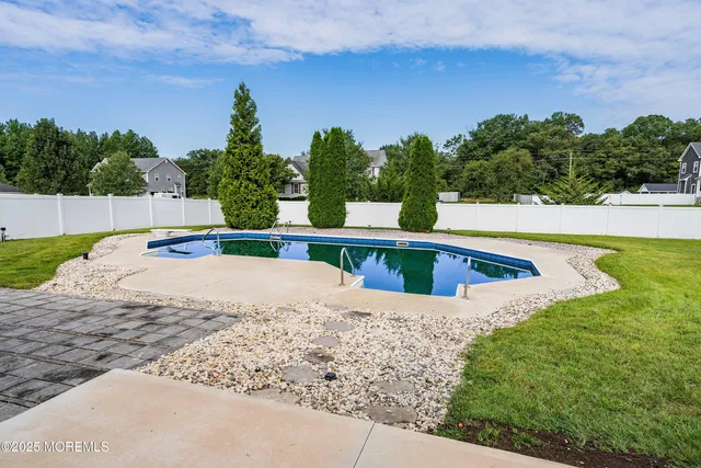 a view of a swimming pool with a yard