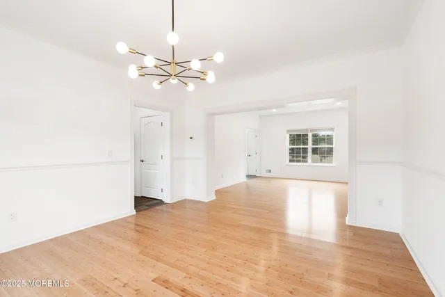 a view of a room with a ceiling fan and a window