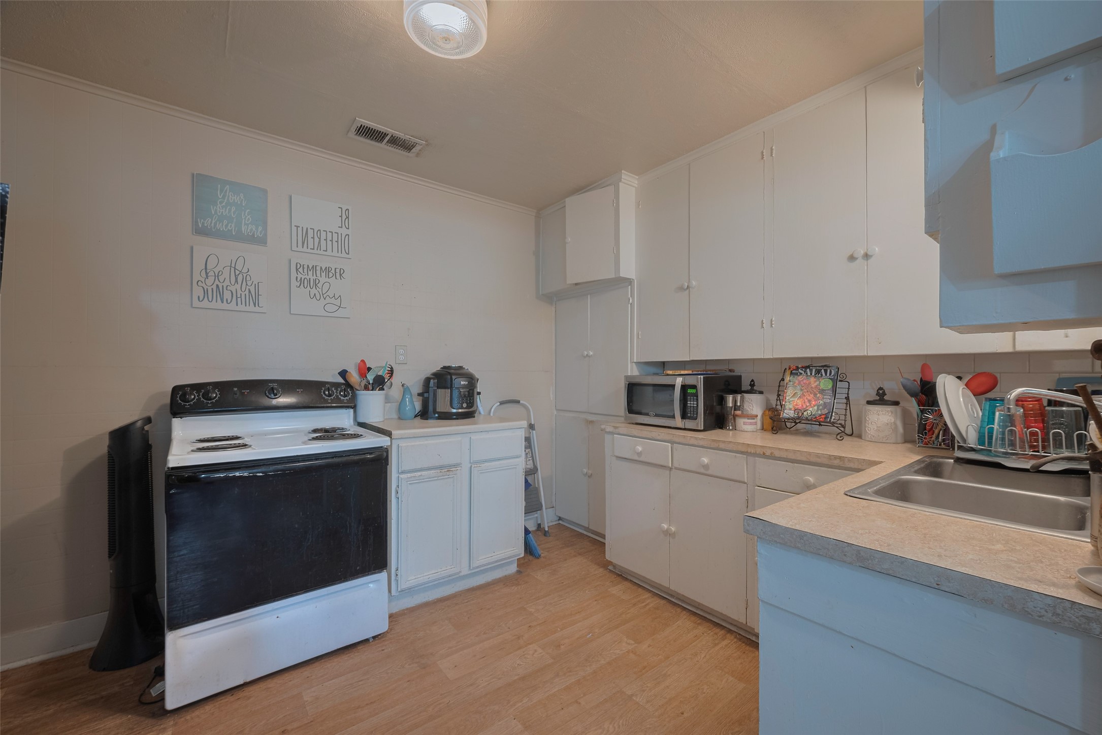 600 Texas Street Wharton, TX 77488 - Photo 19 of 38 a kitchen with a stove and a sink