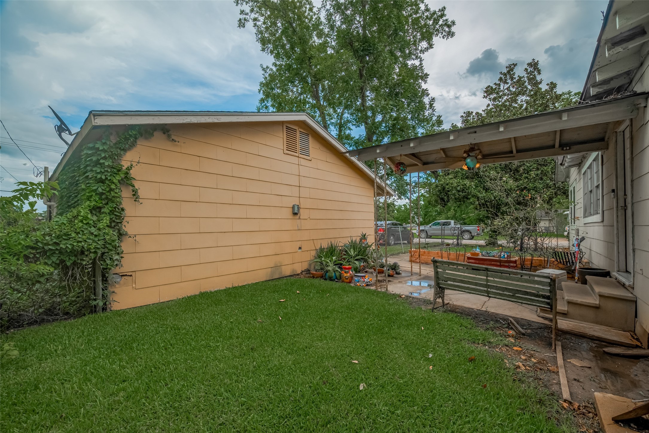600 Texas Street Wharton, TX 77488 - Photo 35 of 38 a backyard of a house with chairs and wooden fence