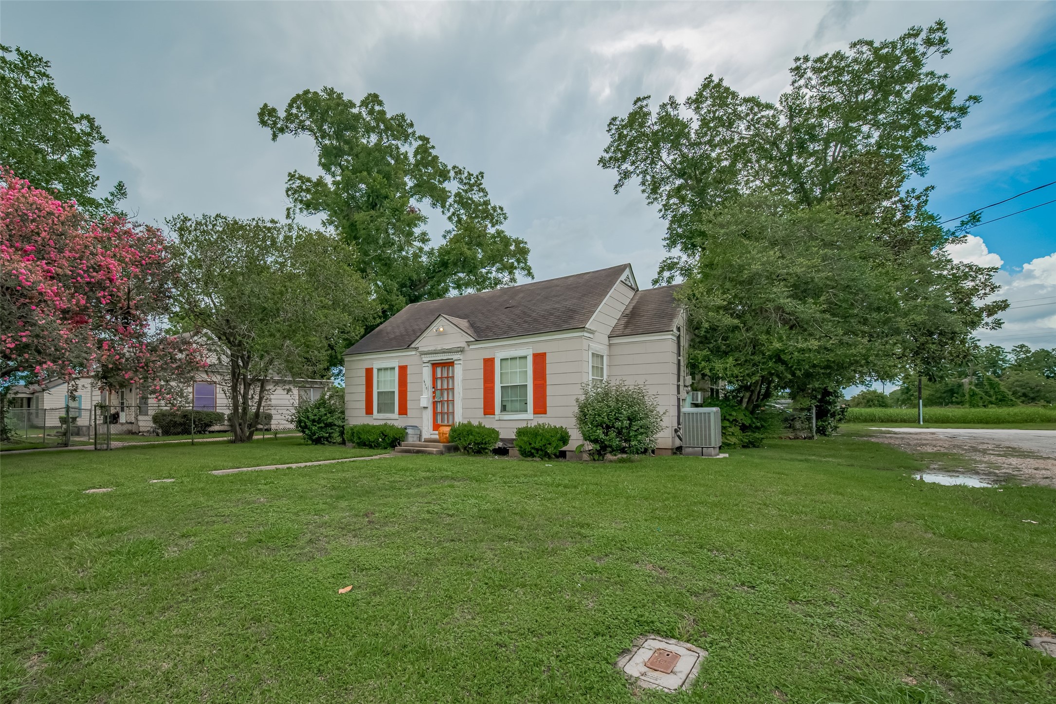 600 Texas Street Wharton, TX 77488 - Photo 5 of 38 a view of a house with a big yard potted plants and large tree