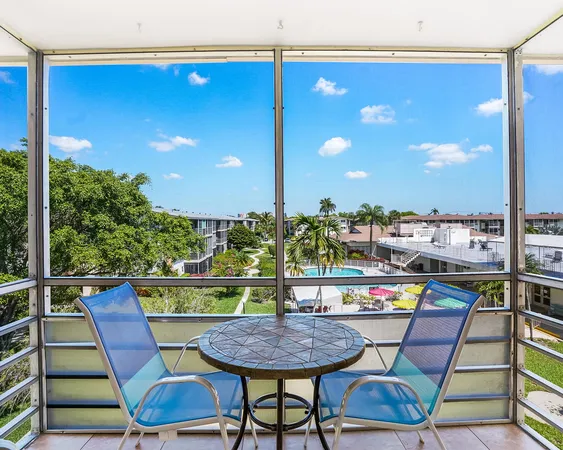 a view of a chairs and table in the balcony