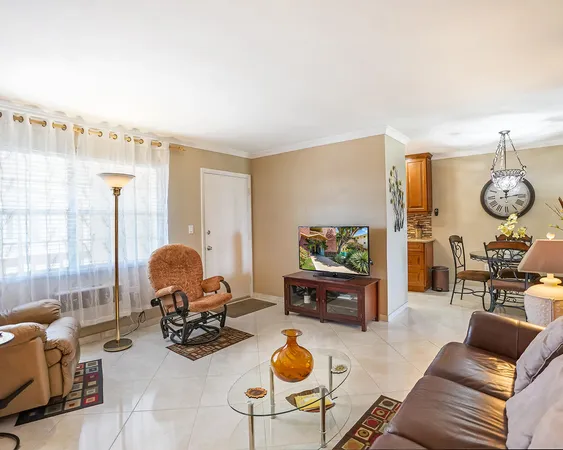 a living room with furniture a rug and a large window