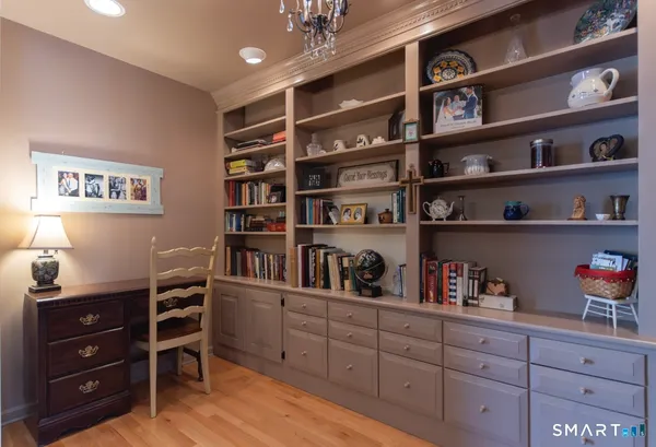 a room with a bookshelf and a book shelf