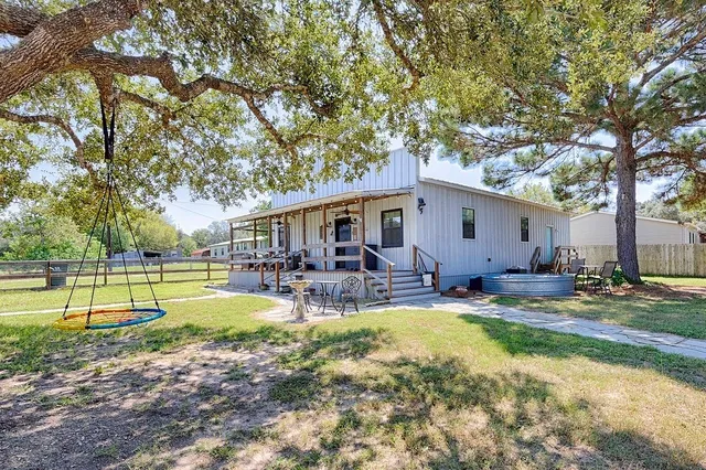 a view of a house with swimming pool and sitting area
