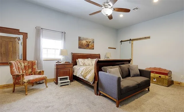 a bedroom with a bed and a couch