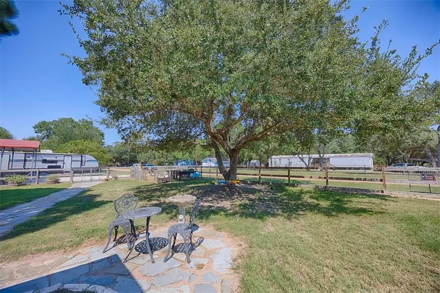 a backyard of a house with table and chairs