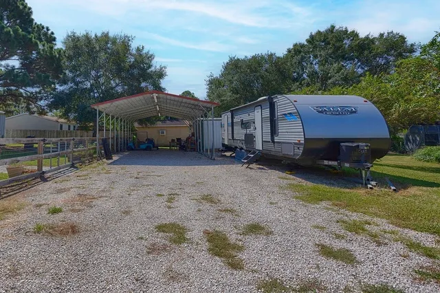 a view of a house with a yard and sitting area