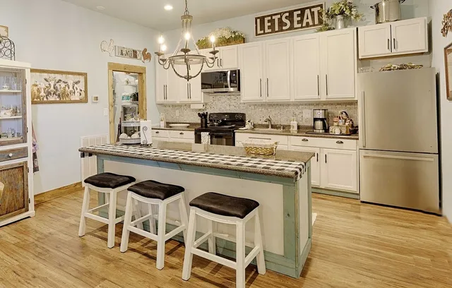 a kitchen with granite countertop cabinets and stainless steel appliances