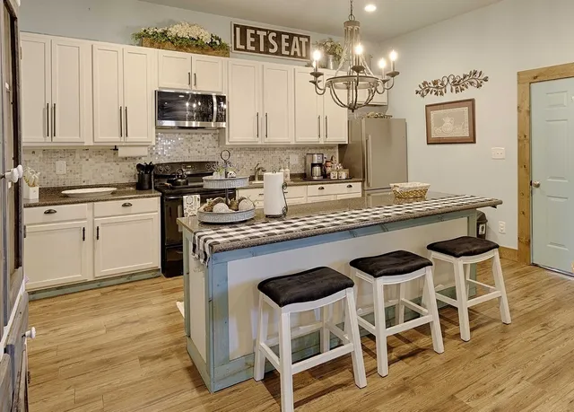 a kitchen with a stove a sink and a refrigerator