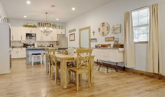 view of a dining room kitchen with furniture and wooden floor