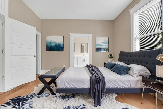 a bedroom with a bed a table and chair