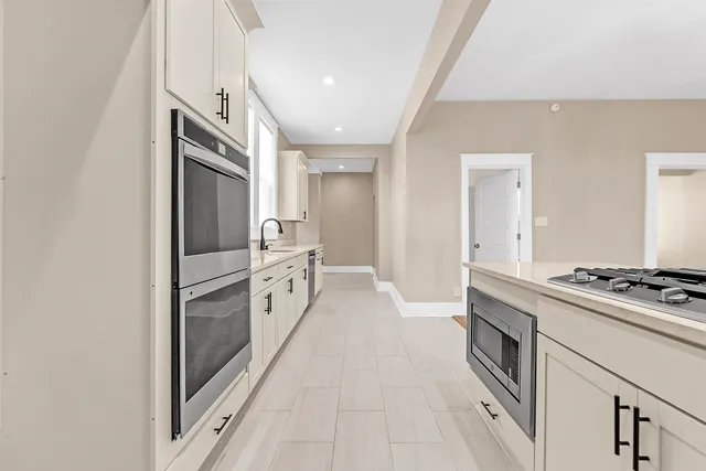 a kitchen with white cabinets and white appliances
