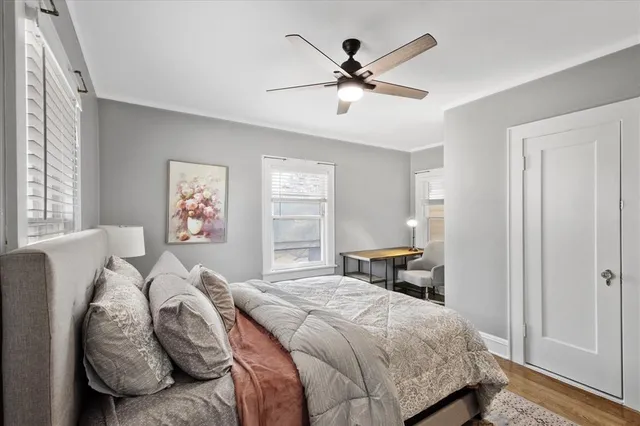 a bedroom with a large bed and a chandelier
