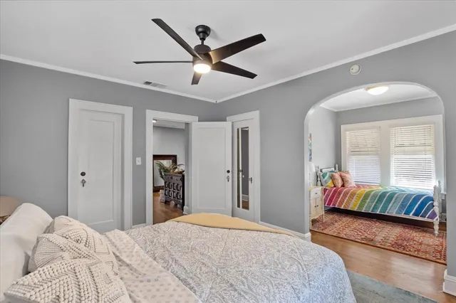 a bedroom with a large bed and a chandelier