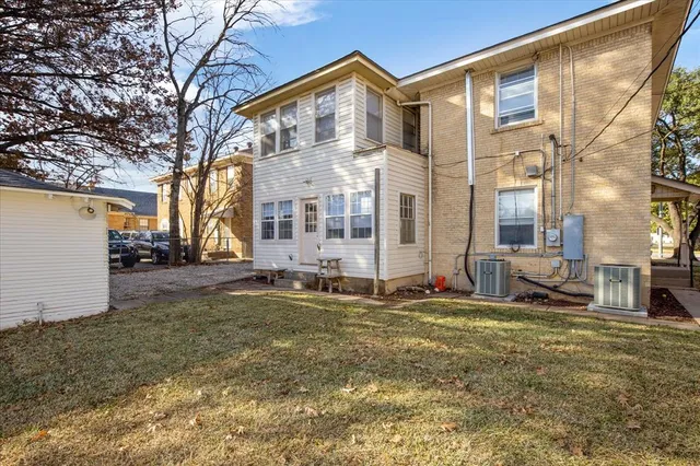 a view of a house with a large windows and a yard