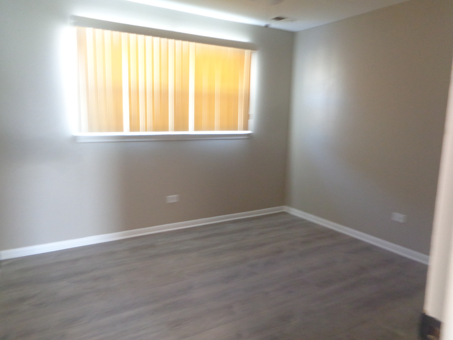 11953 South Lawndale Avenue, Unit 5C2 Alsip, IL 60803 - Photo 11 of 12 an empty room with wooden floor and a window