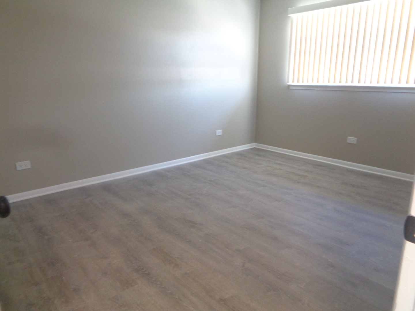 11953 South Lawndale Avenue, Unit 5C2 Alsip, IL 60803 - Photo 10 of 12 an empty room with wooden floor and windows