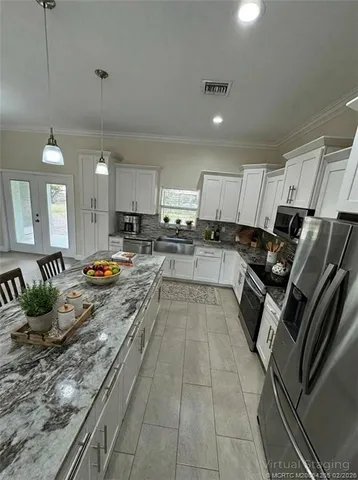 a view of a room with lots of wooden furniture and a chandelier