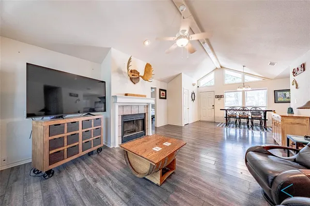 a living room with furniture fireplace and flat screen tv
