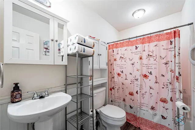 a bathroom with a sink toilet and shower