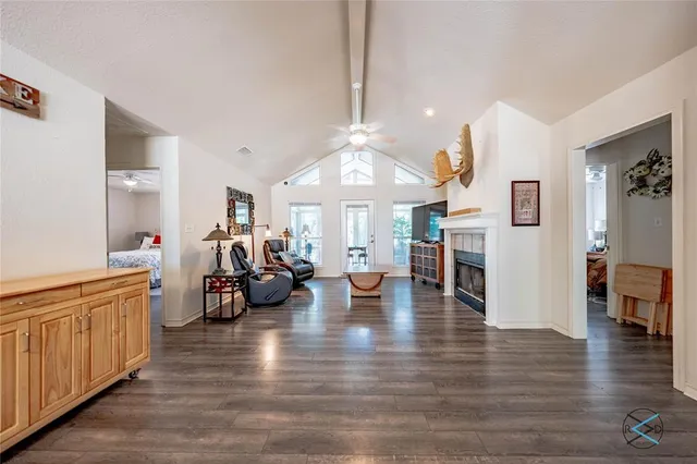 a living room with fireplace furniture and a wooden floor