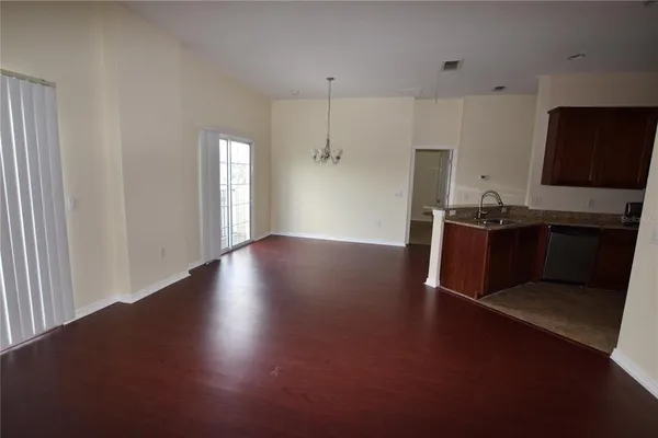 a living room with hard wood floors and a wooden floor