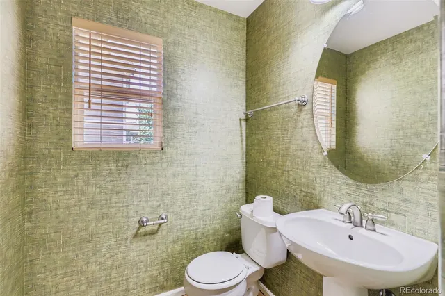 a bathroom with a sink a toilet and mirror