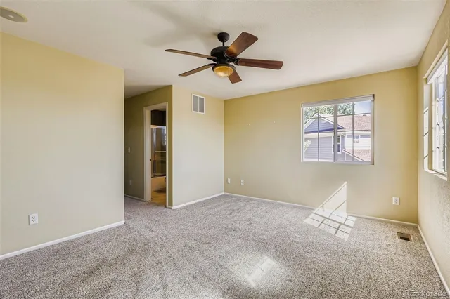 a view of a livingroom with a ceiling fan and window