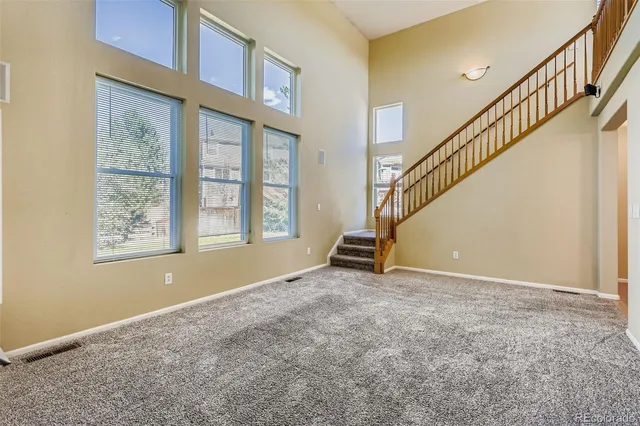 a view of an empty room with stairs