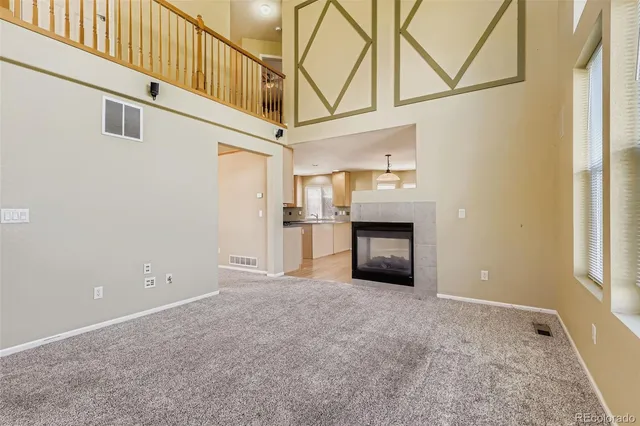 a view of a hallway with an entryway and a kitchen