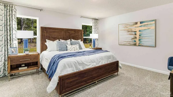 a bed sitting in a bedroom next to a window