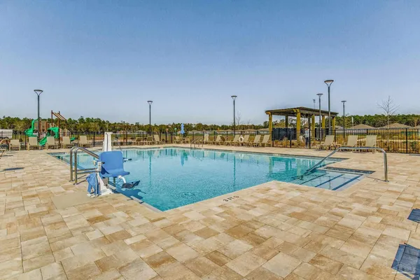a view of a swimming pool with a lawn chairs