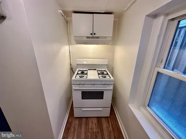 a view of washer and dryer with kitchen in the background