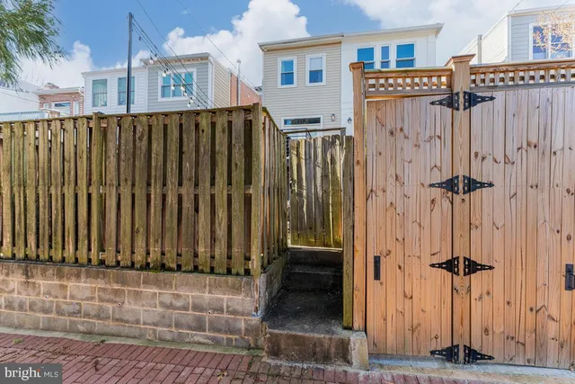 a view of a house with a wooden fence