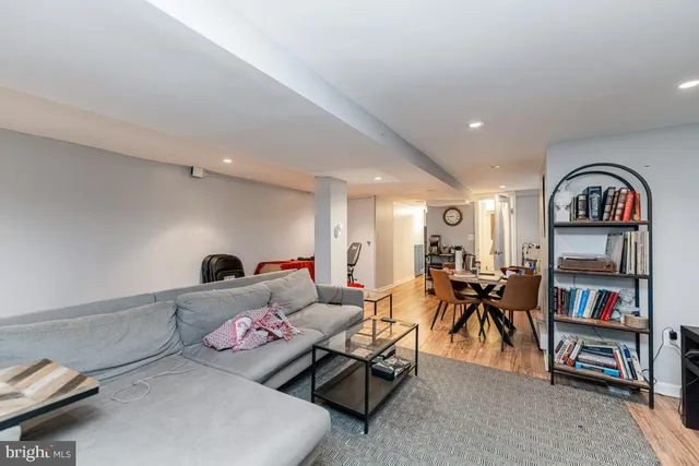 a living room with furniture and a book shelf