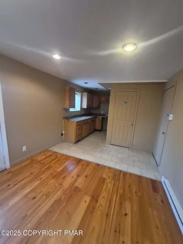 a view of a room with wooden floor
