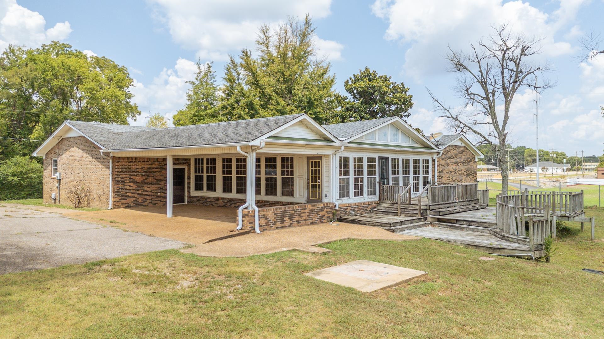 70 South Riverside Drive Savannah, TN 38372 - Photo 18 of 40 a front view of a house with a garden and patio