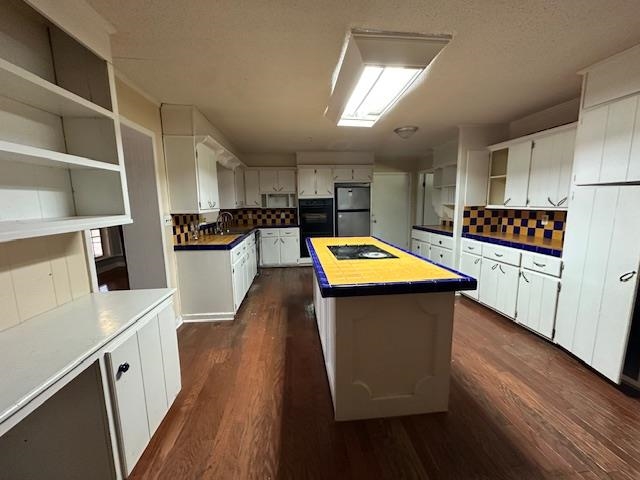 70 South Riverside Drive Savannah, TN 38372 - Photo 8 of 40 a kitchen with stainless steel appliances wooden floors sink and cabinets