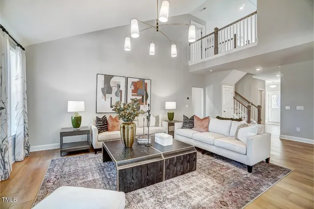 a living room with furniture and a chandelier