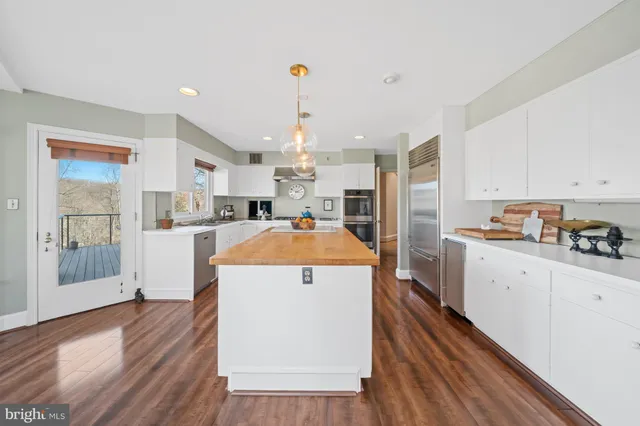 a view of a livingroom with furniture a dinning room and wooden floor