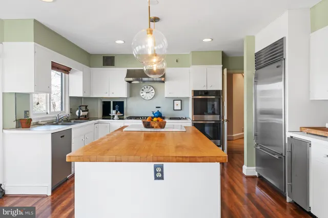 a view of walk in closet with clothes