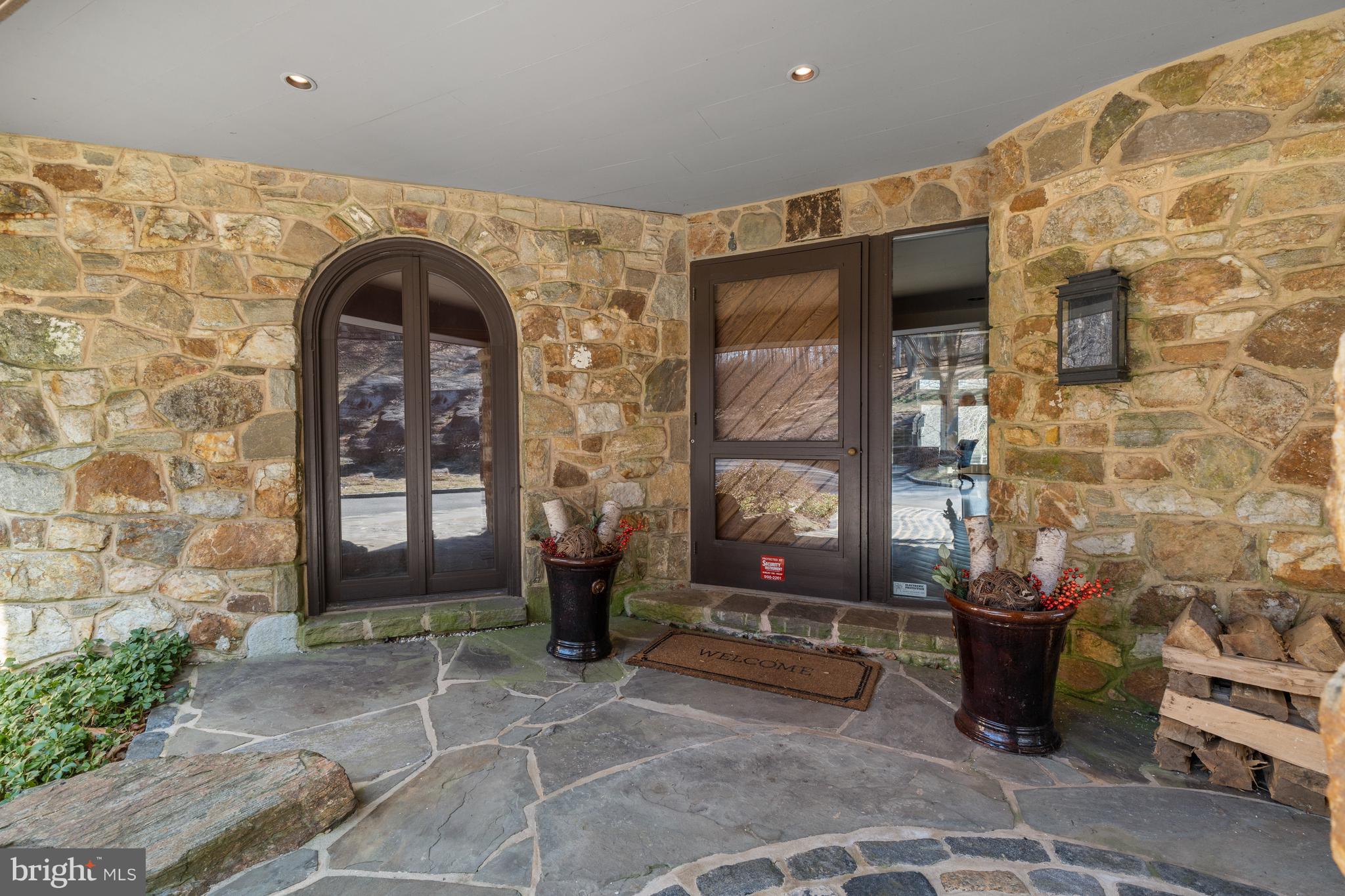 3930 Thompsons Bridge Road Wilmington, DE 19807 - Photo 3 of 69 a living room with fireplace furniture and floor to ceiling windows