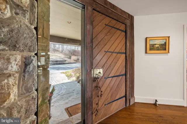 a view of entryway livingroom and hall with wooden floor